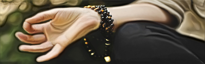 Lady meditating with mala beads bracelet